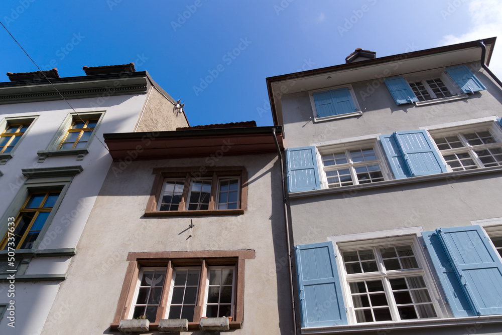 Medieval old town of City of Basel with beautiful historic houses on a blue cloudy spring day. Photo taken April 27th, 2022, Basel, Switzerland.