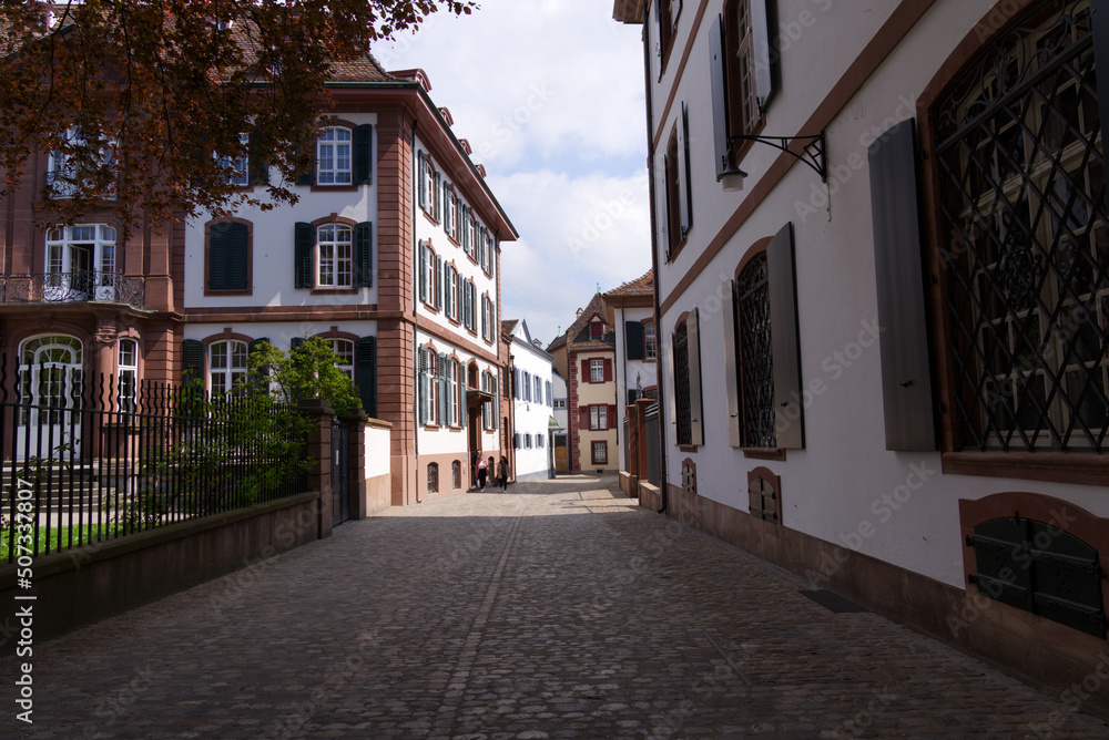 Alley with historic medieval houses at the old town of Basel on a sunny spring day. Photo taken April 27th, 2022, Basel, Switzerland.
