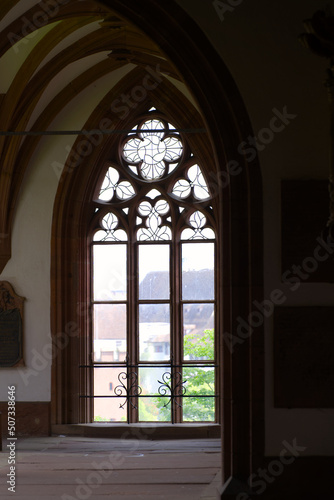 Beautiful window at cloister of Basler Minster at the old town built with red sandstone on a blue cloud spring day. Photo taken April 27th  2022  Basel  Switzerland.