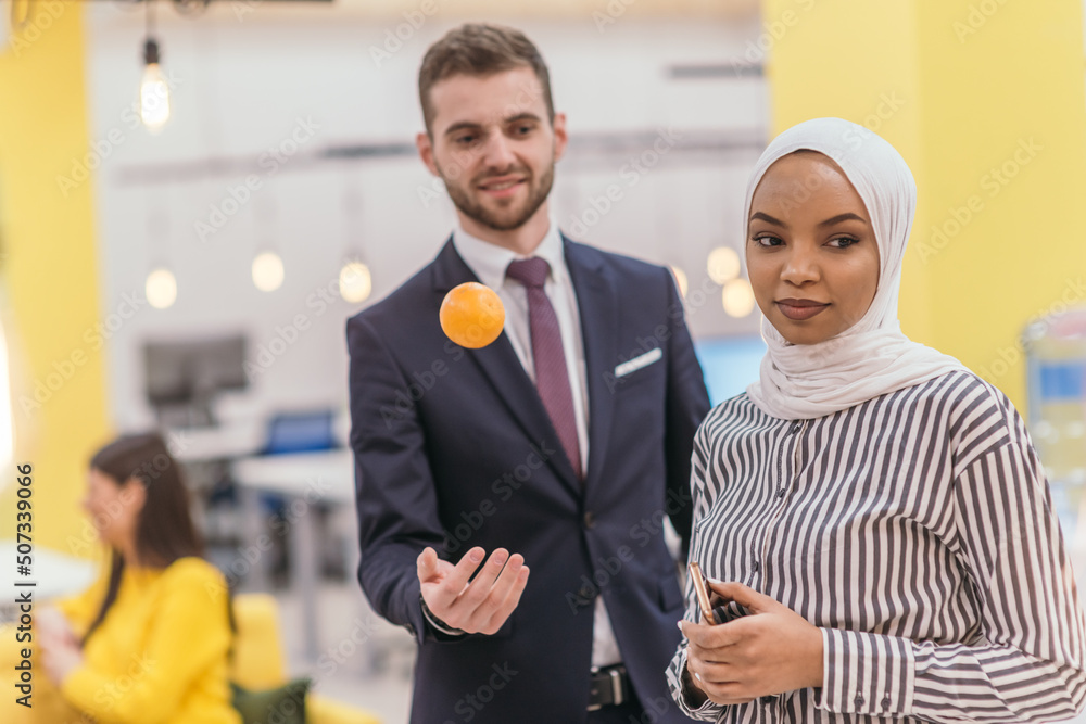 Portrait of a Muslim African American businesswoman at work while standing in the middle of a modern office. Portrait of a Muslim African American businesswoman at work while standing in the middle of a modern office.