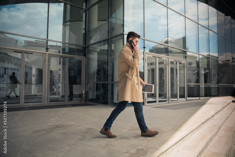Talking on his phone while walking Talking on his phone while walking