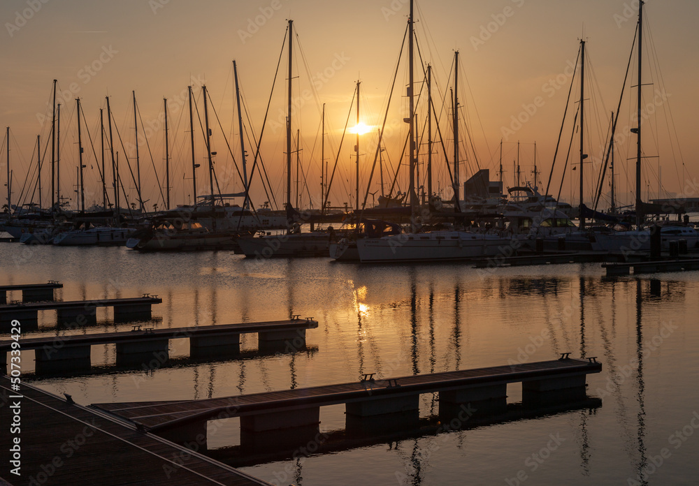 ships moored in the port of la linea de la concepcion in front of gibraltar at sunset