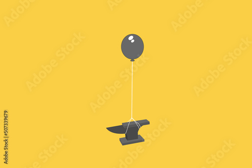 black helium balloon lifting heavy iron anvil. Concept of difficult business.