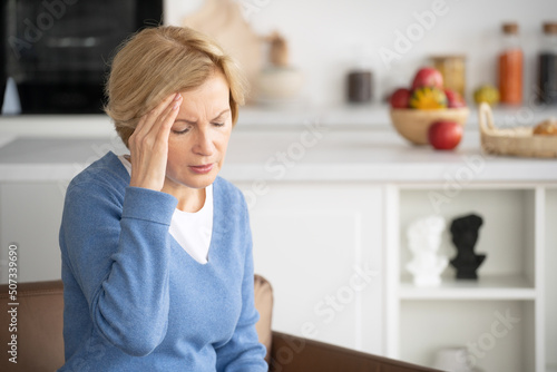 Sick middle aged woman suffering from headache