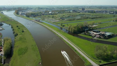 Speedboat Navigating On Gouwekanaal In Gouda, Netherlands. aerial tracking shot photo