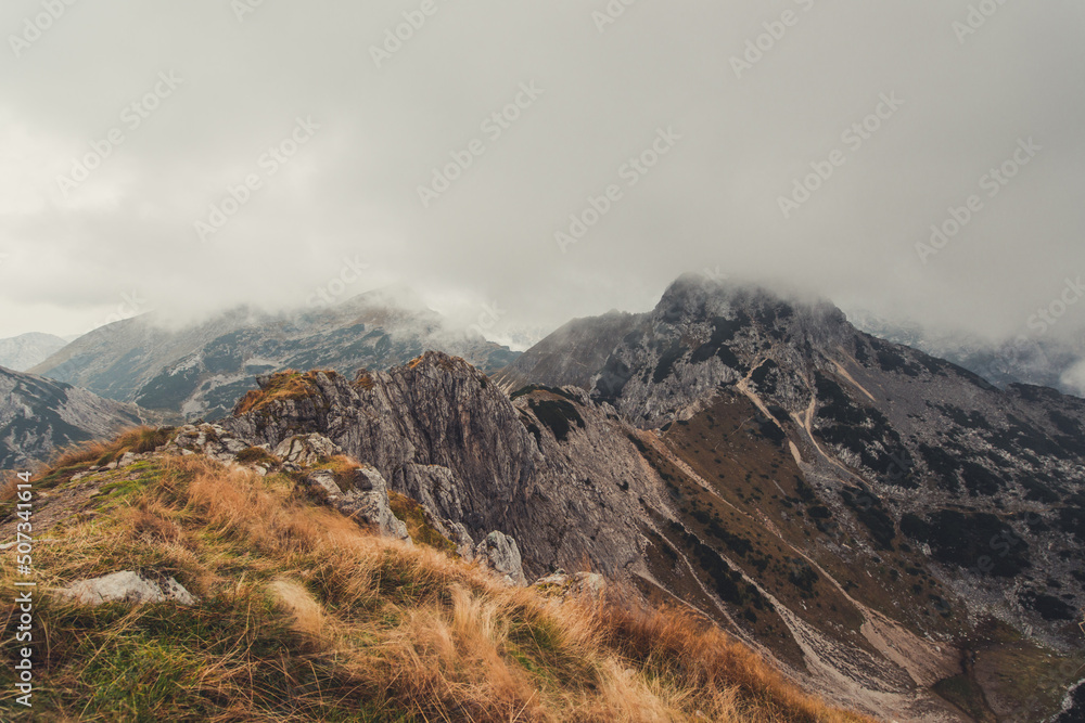 Obraz premium Misty and foggy morning on top of the hill Visevnik. Cloudy mountain panorama in the Julian Alps