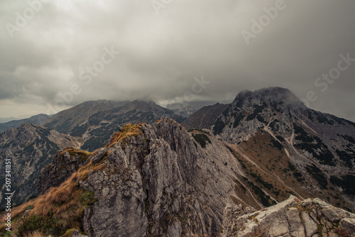 Misty and foggy morning on top of the hill Visevnik. Cloudy mountain panorama in the Julian Alps