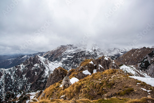 Misty and foggy morning on top of the hill Visevnik. Cloudy mountain panorama in the Julian Alps