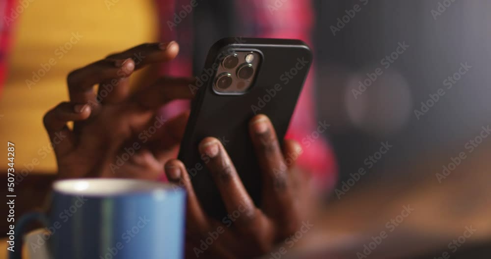 4k, Attractive young woman texting with cell phone at kitchen table at home. 4k, Attractive young woman texting with cell phone at kitchen table at home.