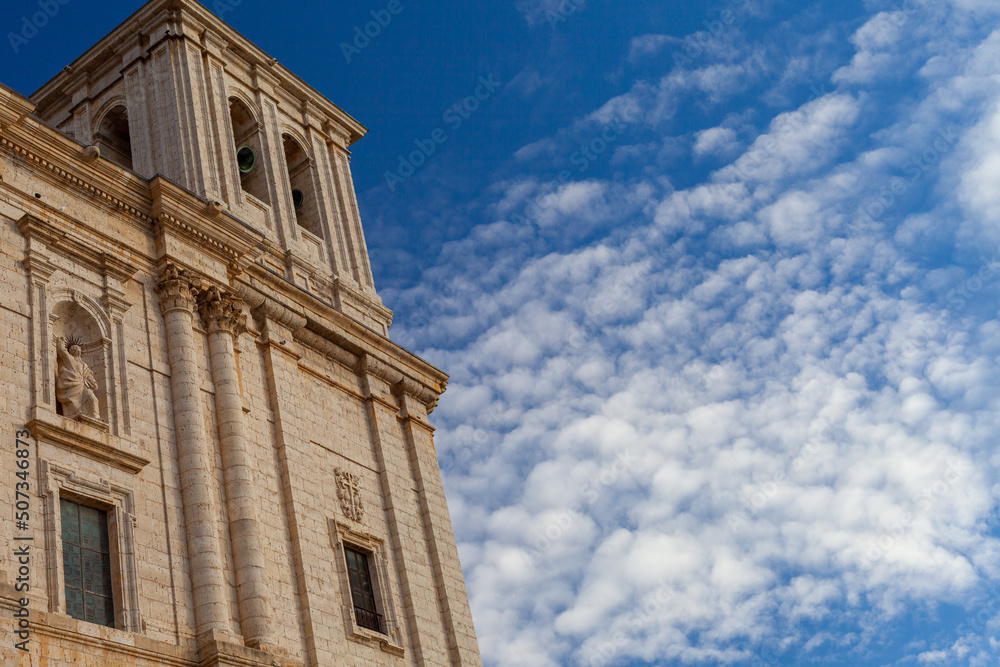 front facade of a Spanish Catholic church with blue sky in the background
