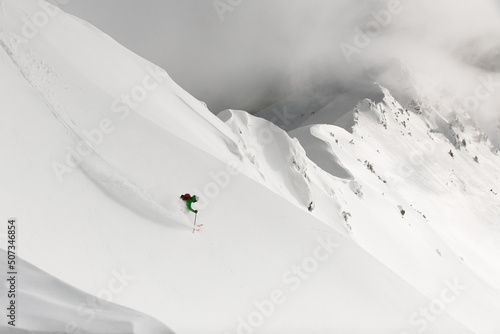 Great view from drone on man freerider riding down from top of ridge.