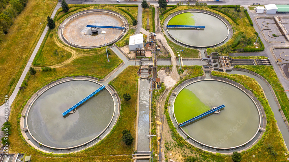Aerial view of the tanks of a sewage and water treatment plant enabling the discharge and re-use of waste water. It's a sustainable water recycling with treatment plant. Aerial view of the tanks of a sewage and water treatment plant enabling the discharge and re-use of waste water. It's a sustainable water recycling with treatment plant.