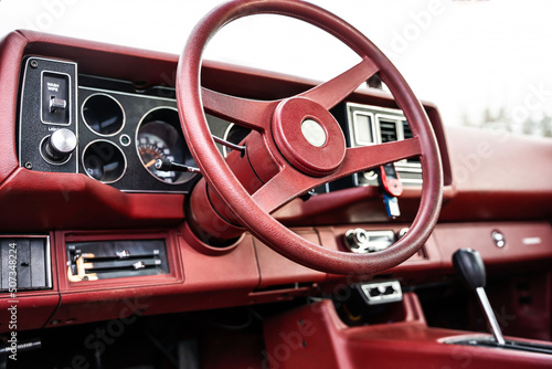 red steering wheel, dashboard of an old powerful classic American car