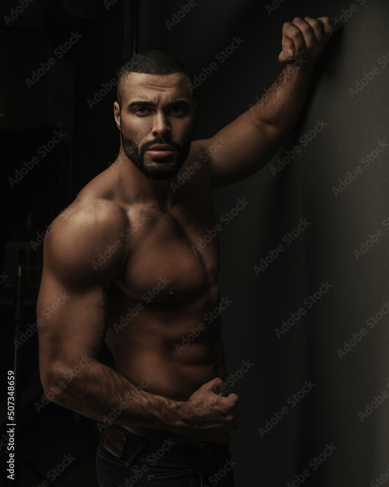 Studio shot of sexy shirtless hunk in jeans