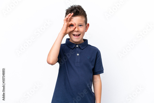 Little caucasian boy isolated on white background showing ok sign with fingers