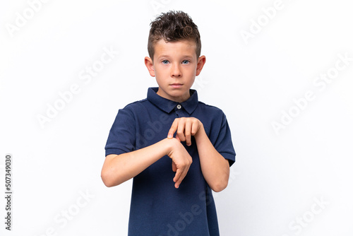 Little caucasian boy isolated on white background making the gesture of being late