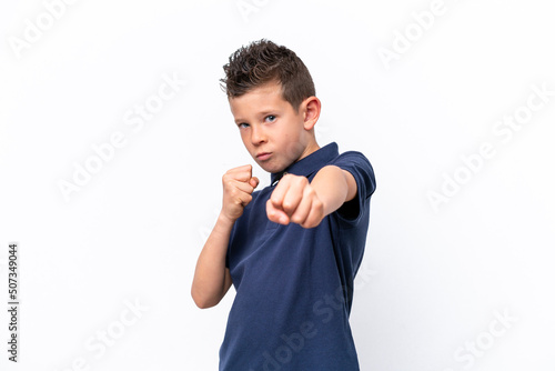 Little caucasian boy isolated on white background with fighting gesture
