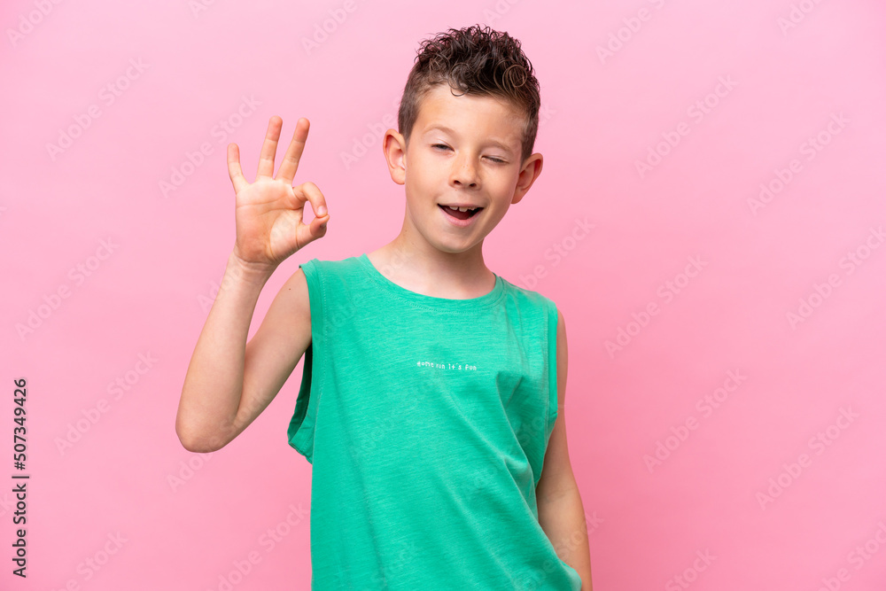 Little caucasian boy isolated on pink background showing ok sign with fingers Little caucasian boy isolated on pink background showing ok sign with fingers