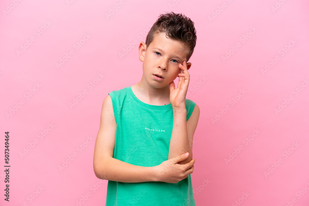 Little caucasian boy isolated on pink background with headache Little caucasian boy isolated on pink background with headache