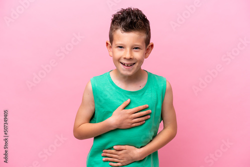 Quadro su tela Little caucasian boy isolated on pink background smiling a lot