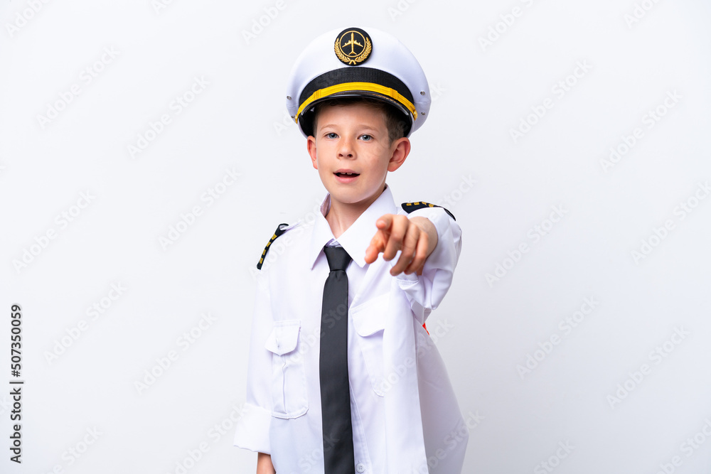 Little airplane pilot boy isolated on white background surprised and pointing front Little airplane pilot boy isolated on white background surprised and pointing front
