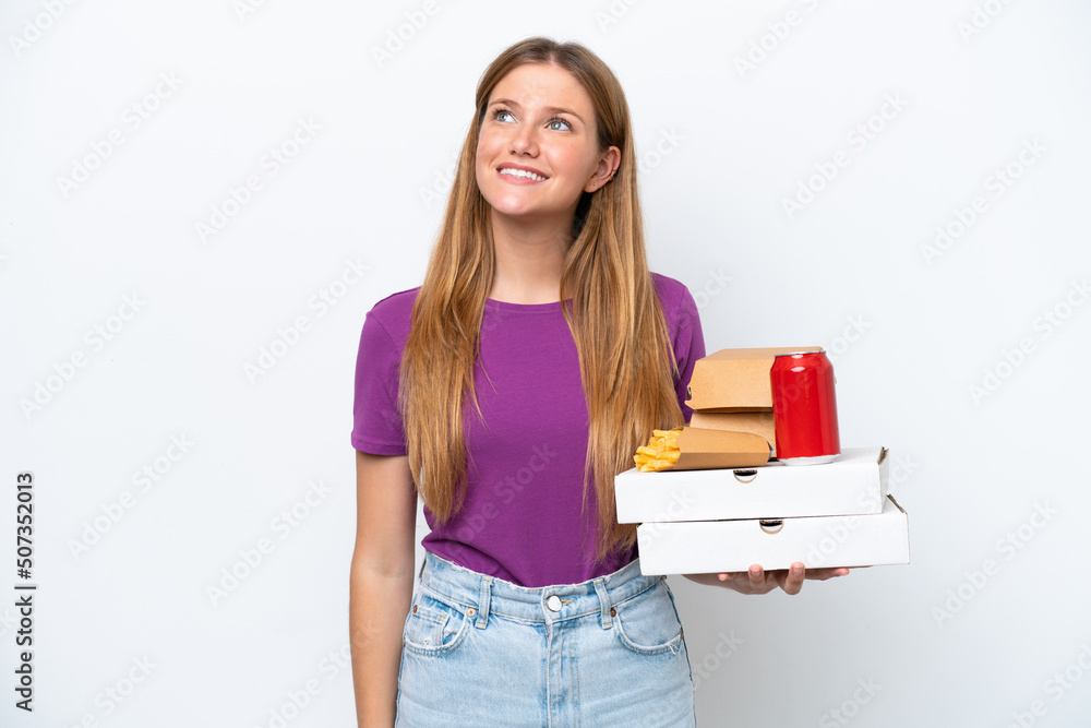 Young pretty blonde woman holding fast food isolated on white background thinking an idea while looking up Young pretty blonde woman holding fast food isolated on white background thinking an idea while looking up