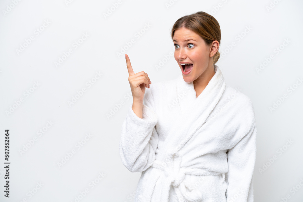 Young pretty blonde woman in bathrobe isolated on white background intending to realizes the solution while lifting a finger up