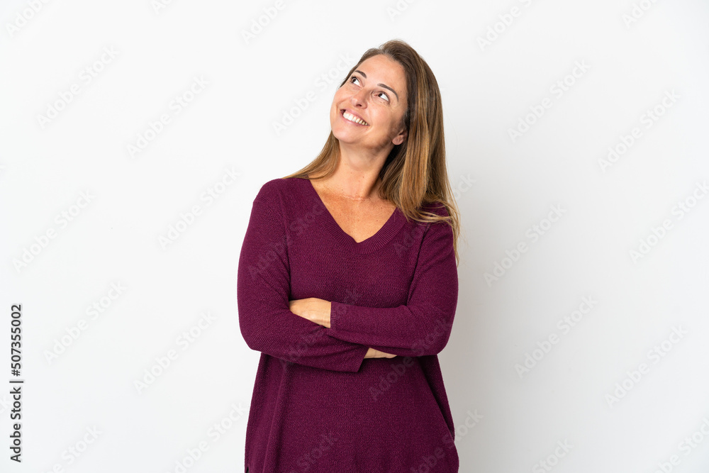 Middle age Brazilian woman isolated on white background looking up while smiling Middle age Brazilian woman isolated on white background looking up while smiling
