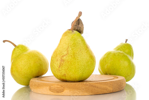 Three juicy bright yellow pears with a wooden tray, close-up, isolated on a white background.