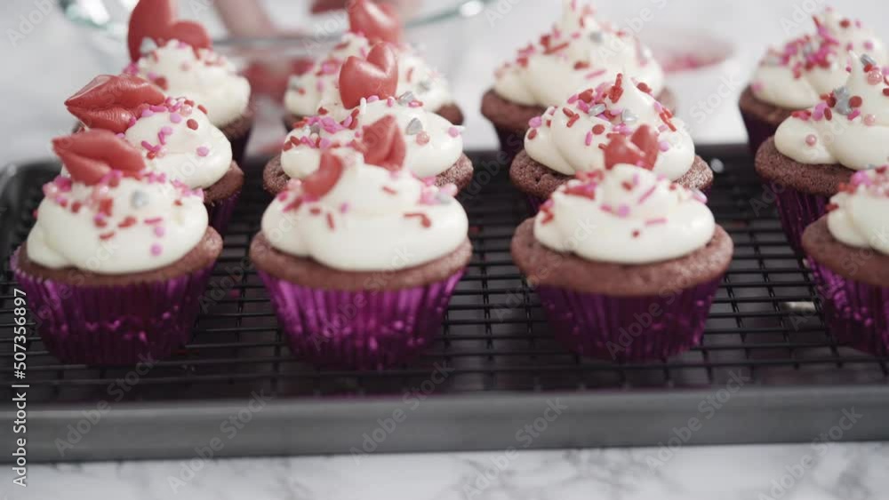 Step by step. Decorating red velvet cupcakes with sprinkles and chocolate hearts and kisses. Step by step. Decorating red velvet cupcakes with sprinkles and chocolate hearts and kisses.