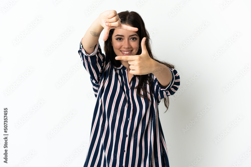 Young caucasian woman over isolated background focusing face. Framing symbol Young caucasian woman over isolated background focusing face. Framing symbol