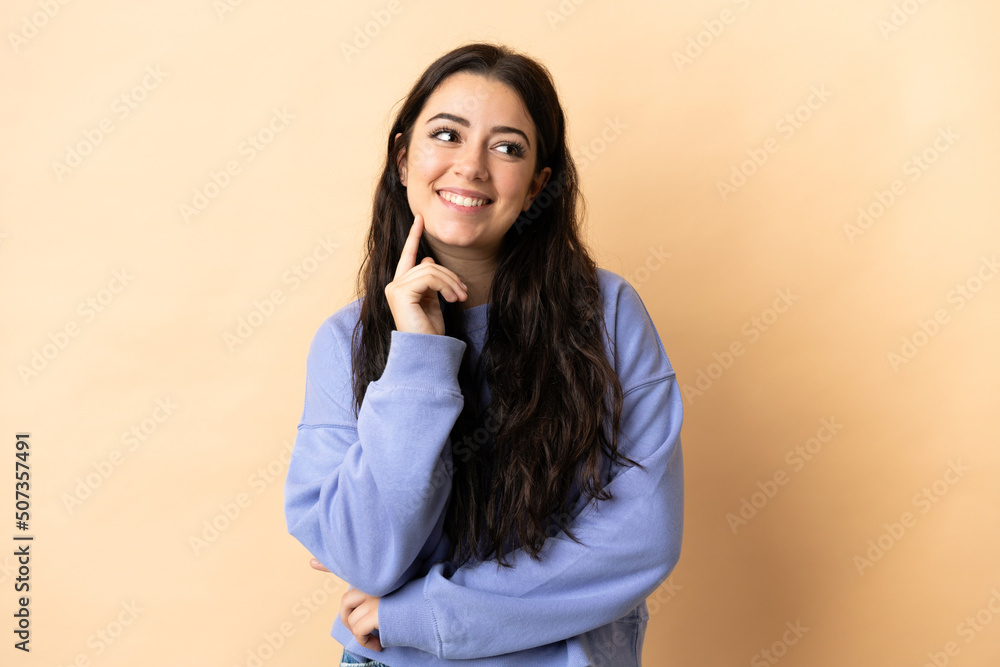 Young caucasian woman over isolated background thinking an idea while looking up Young caucasian woman over isolated background thinking an idea while looking up