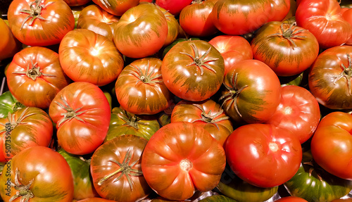 Fresh ripe organic kumato tomatoes at the farmers market in Barcelona, Spain photo