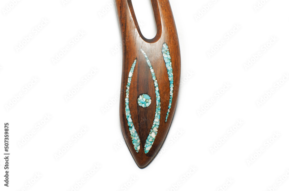 Photo of a woman's wooden hairpin on a white background. Object shooting. Content for jewelry and accessories website. A perfect gift for your girlfriend, sister or mother. Photo of a woman's wooden hairpin on a white background. Object shooting. Content for jewelry and accessories website. A perfect gift for your girlfriend, sister or mother.
