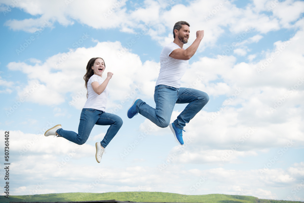 happy father and daughter jump in sky. hurry up