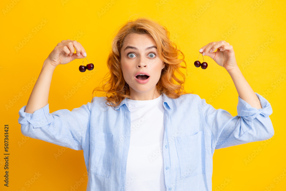 Young stylish woman isolated holding red colorful cherries. Berries harvest season. Summer diet with organic harvesting cherry.