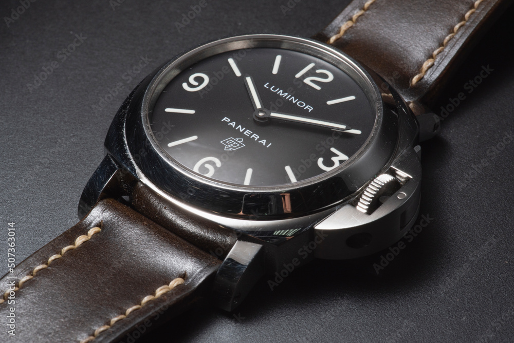 Close up of Panerai Luminor PAM 000 watch isolated on a black background. PAM 000 dive watch features a Sausage dial and iconic crown guard. Stock Photo Adobe Stock