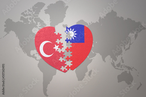 puzzle heart with the national flag of turkey and taiwan on a world map background. Concept.