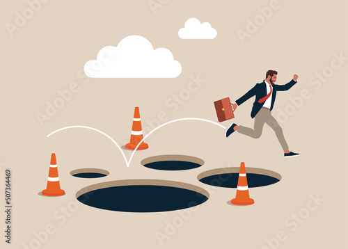 Entrepreneur jump pass many pitfalls to achieve business success. Avoid pitfall, adversity and brave to jump pass mistake or business failure, skill and creativity to solve problem concept. photo