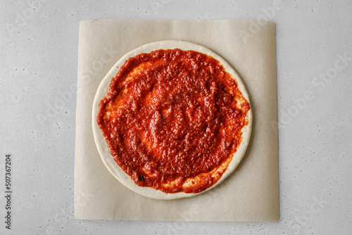 cooking pizza with cheese and tomatoes photo