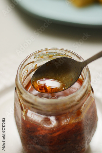 homemade pepper sauce jar witha spoon photo