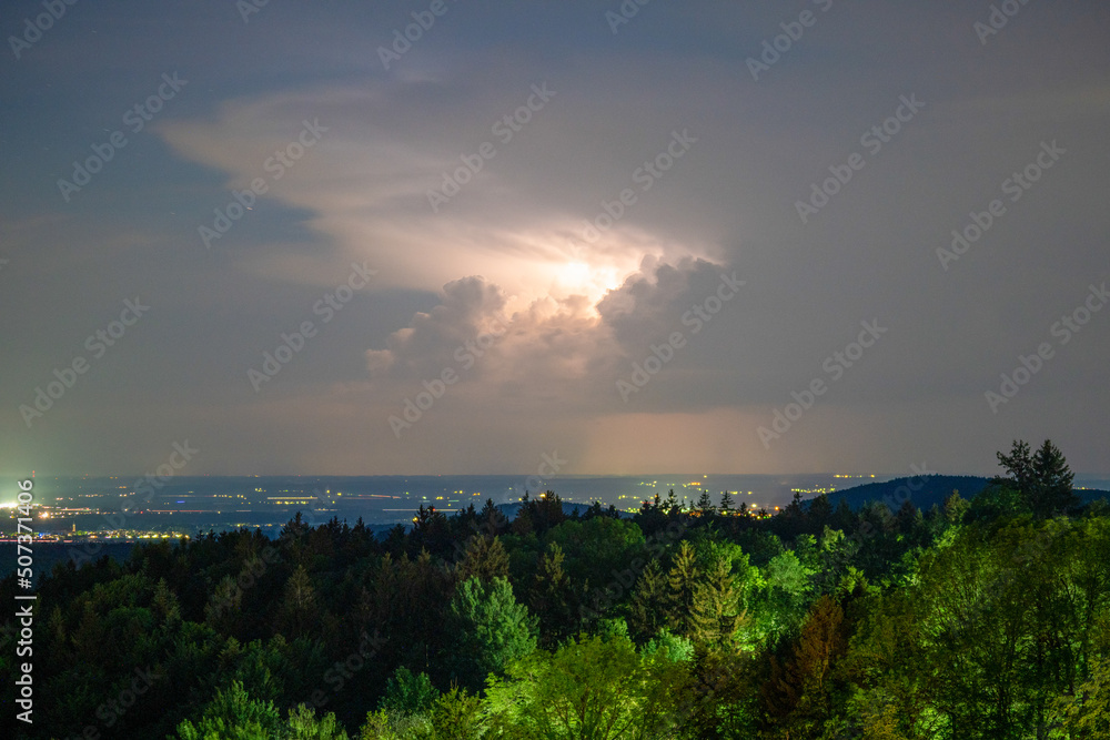 Thunderstorm in the Bavarian Forest with dark clouds and bright sheet lightning