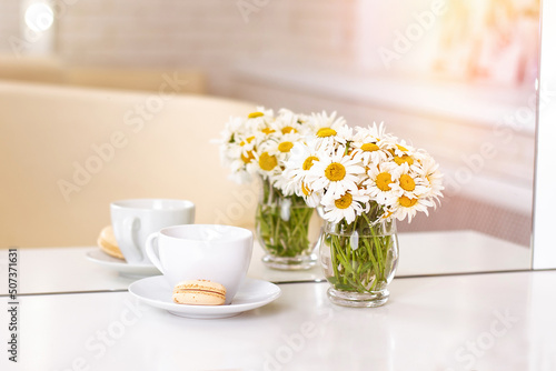 Wallpaper Mural Client's place in hairdressing and beauty salon with cup of tea, macaroon and chamomiles in vase
 Torontodigital.ca