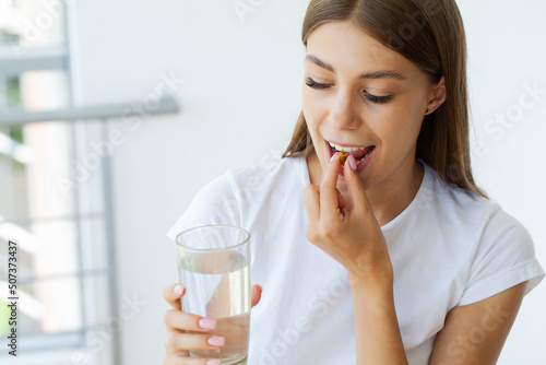 Beautiful Woman Holding Fish Oil Pill In Hand