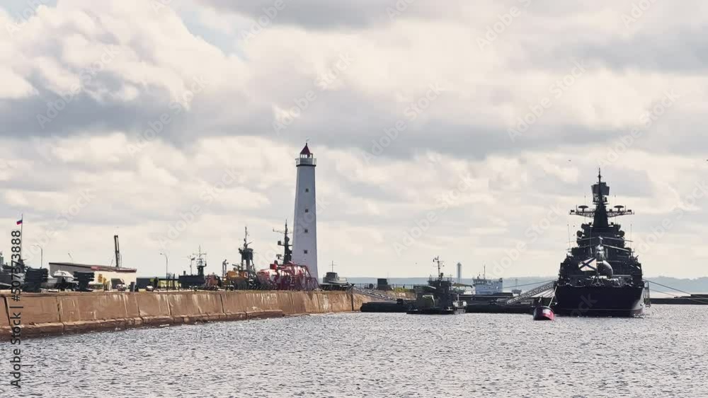 Warships of the most powerful military forces in the parking lot in the city of Kronstadt on a sunny day, Russia, seaport, lighthouse, crane Warships of the most powerful military forces in the parking lot in the city of Kronstadt on a sunny day, Russia, seaport, lighthouse, crane