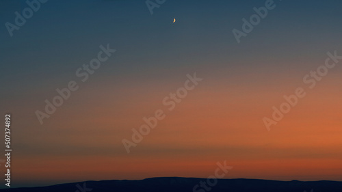 sunset over the mountains, dramatic sky, moon
