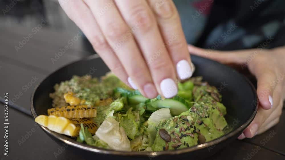 Woman squeezes fresh juice from lemon slice into dish. Healthy salad bowl with porridge avocado and turkey seasoned with fresh lemon juice closeup Woman squeezes fresh juice from lemon slice into dish. Healthy salad bowl with porridge avocado and turkey seasoned with fresh lemon juice closeup