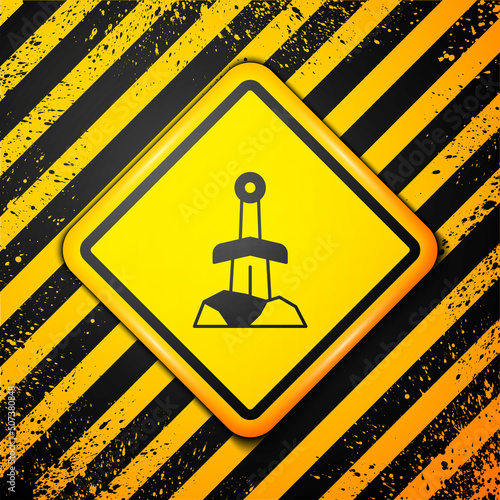 Black Sword in the stone icon isolated on yellow background. Excalibur the sword in the stone from the Arthurian legends. Warning sign. Vector
