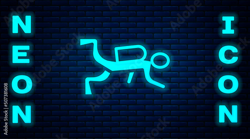 Glowing neon Scuba diver icon isolated on brick wall background. Vector