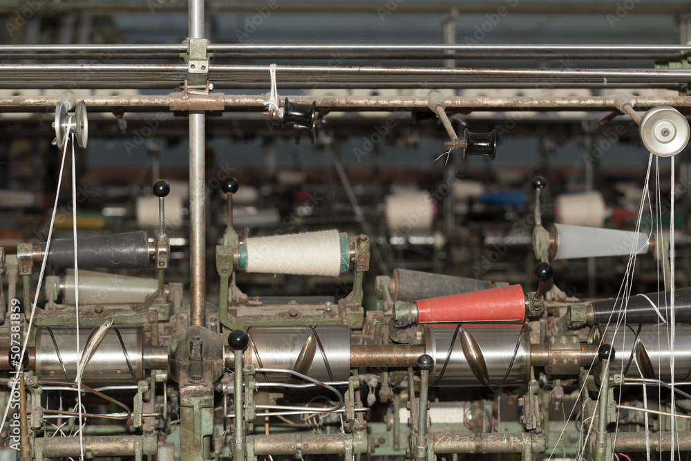 An old textile manufactory. Textile manufacturing. The work of textile processing machines. An old textile manufactory. Textile manufacturing. The work of textile processing machines.